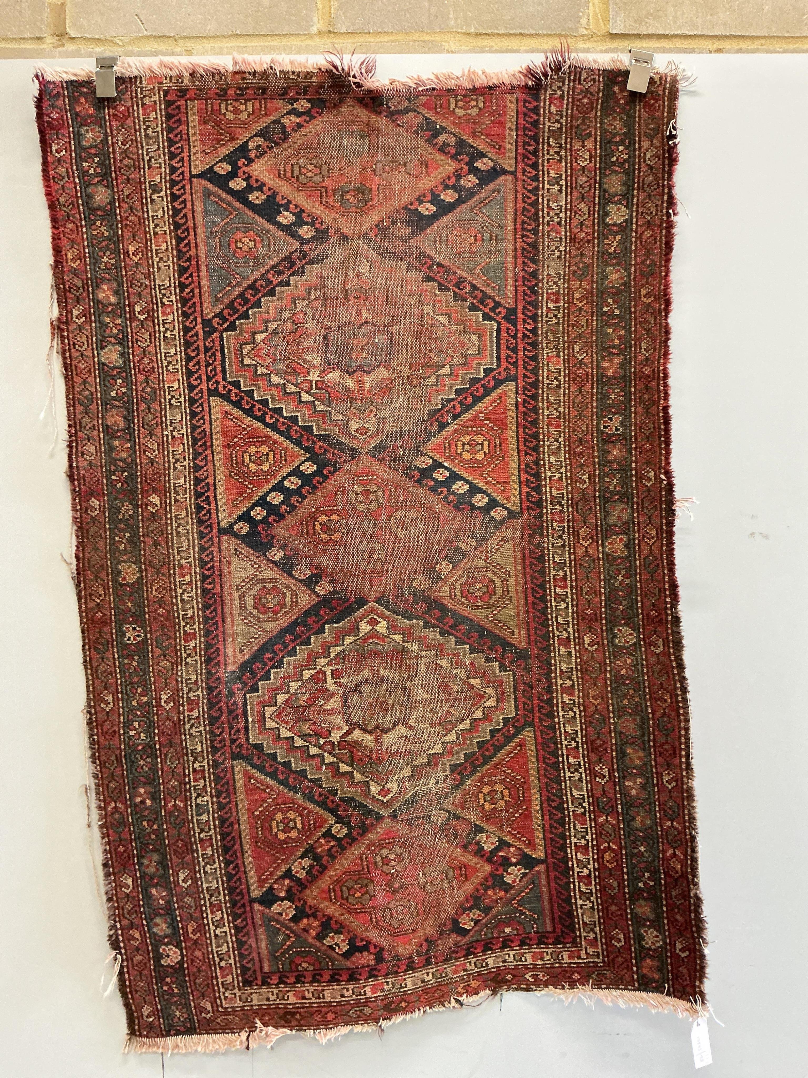 An antique Caucasian blue ground runner and a Caucasian red ground rug (heavily worn), larger 336 x 87cm